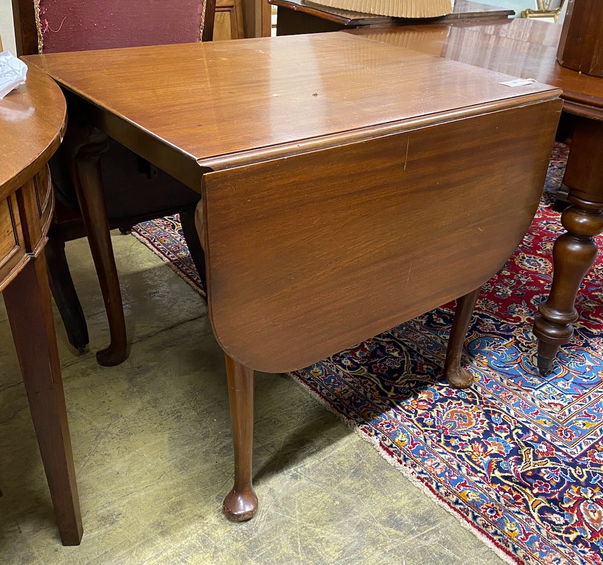A 1920's mahogany drop flap dining table, width 83cm, depth 69cm, height 75cm